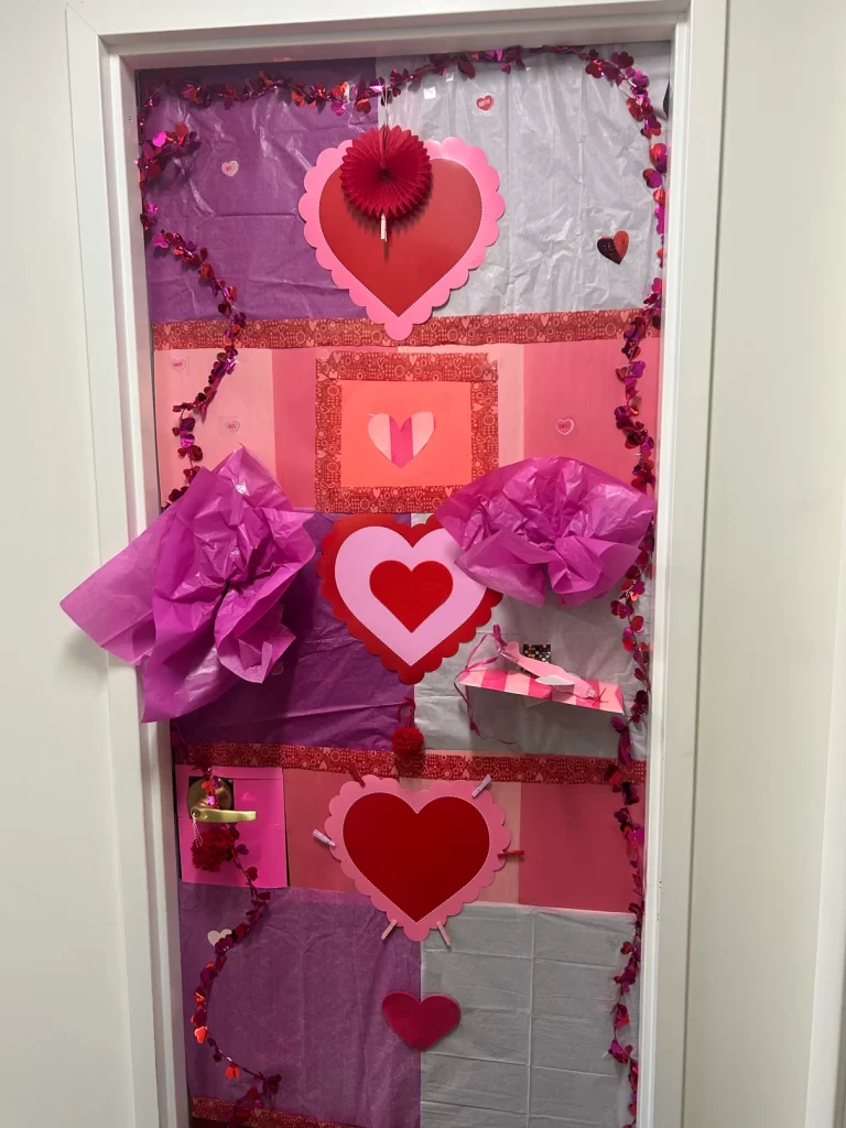 Door decorated in shades of pink and red for the Valentine’s Day Door Decorating Contest