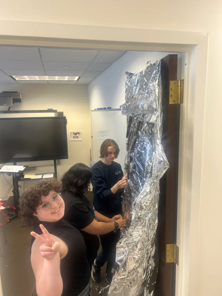 Students decorating their door during the Valentine’s Day Door Decorating Contest