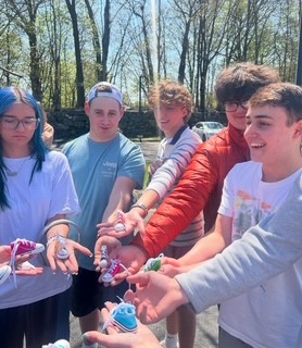 Students participating in this years Walk-a-Thon show off the hidden sneaker tokens they found
