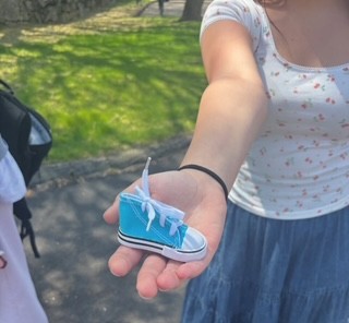 A student shows a sneaker token she found during this years Walk-a-Thon
