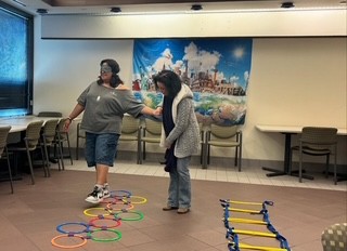 Two people participate in an activity during The Spire Amazing Race