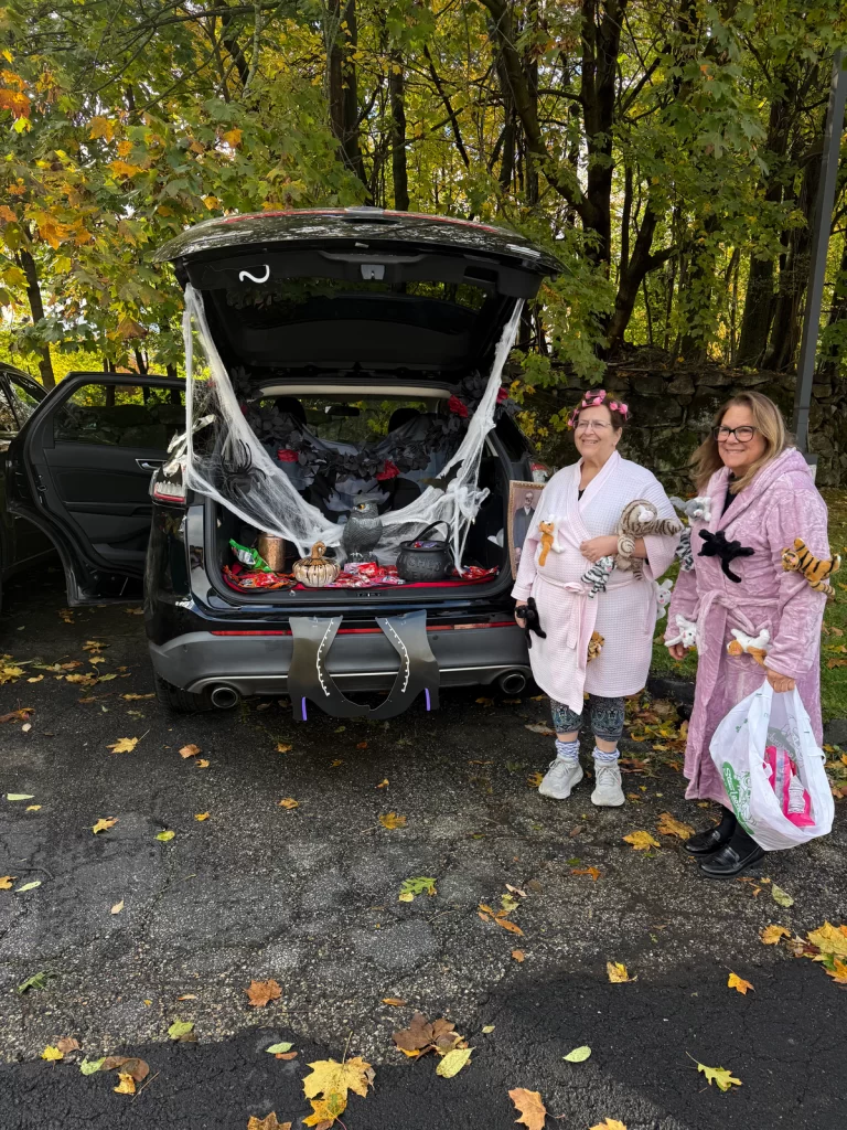 Halloween Truck or Treat two people pose next to their decorated trunk