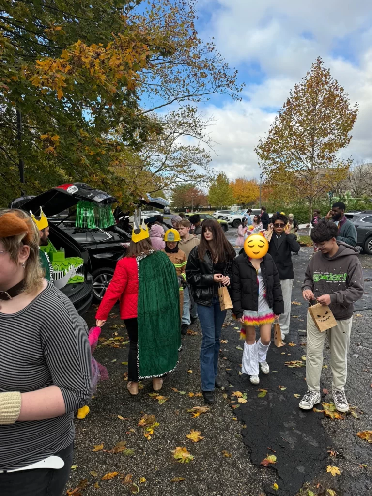 Truck or Treat participants walk through parking lot for halloween