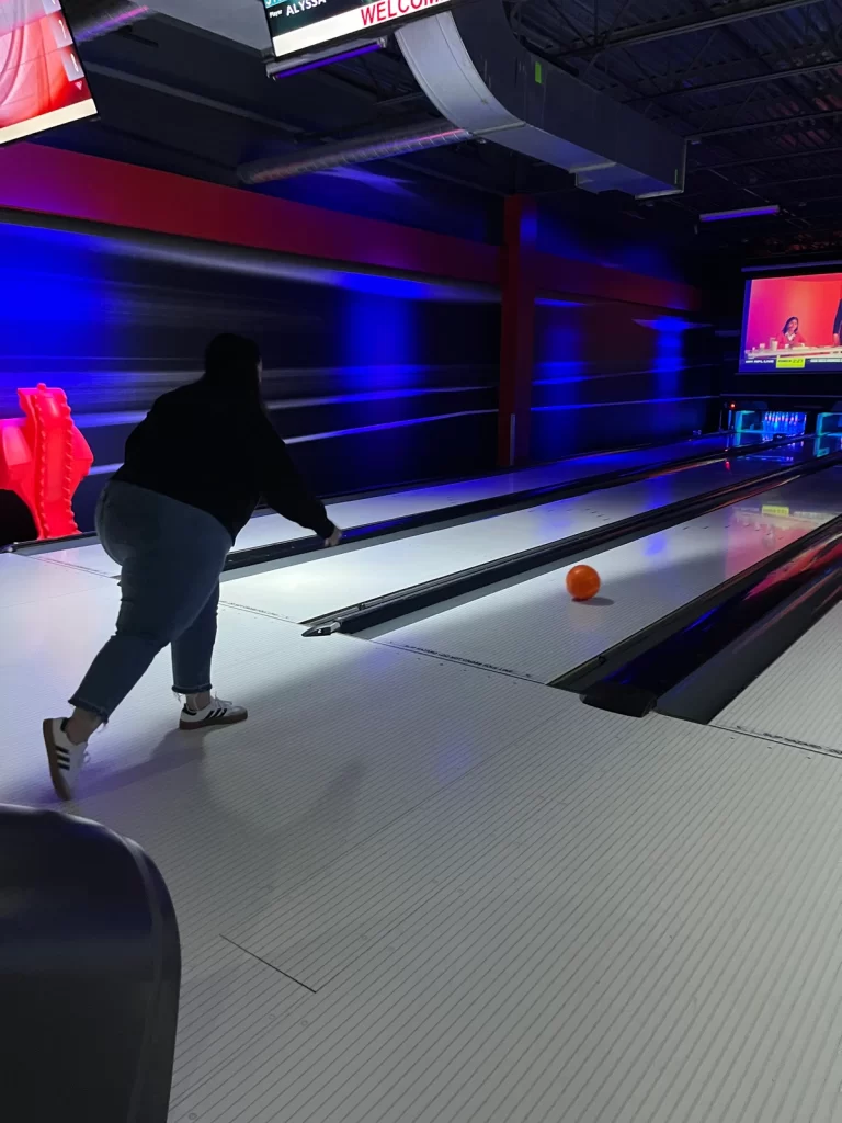 Staff member bowling during RPM Raceway staff outing arranged by Spire Parent community