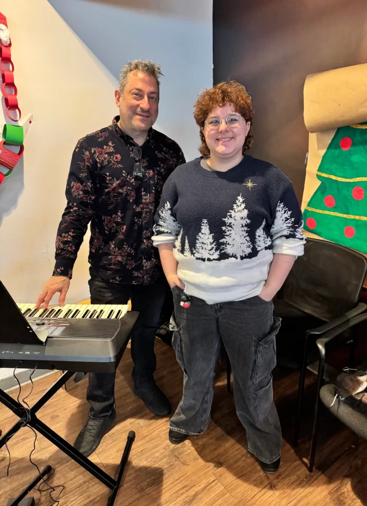 Student and music teacher Jonathan Cahr sharing music at new covenant center